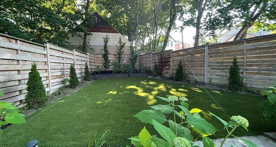 beautiful fenced backyard with artificial turf